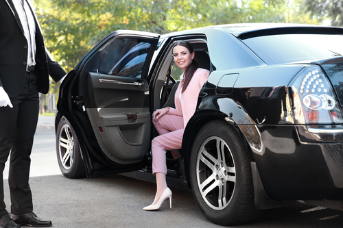 Businesswoman in luxury car - Limo Service to San Diego Airport